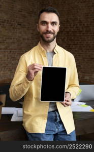 adult male holding tablet office 2