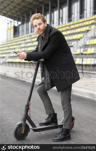 adult male posing with his electric scooter 2