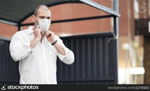 adult male with surgical mask waiting bus
