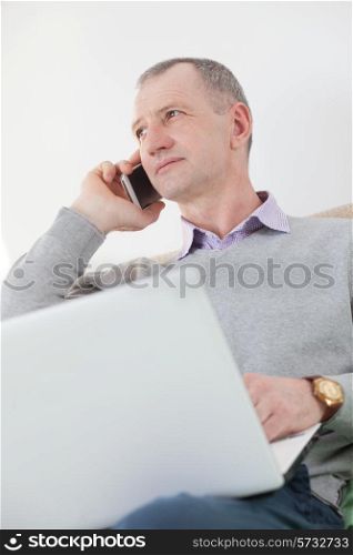 Adult man calling by smartphone at home