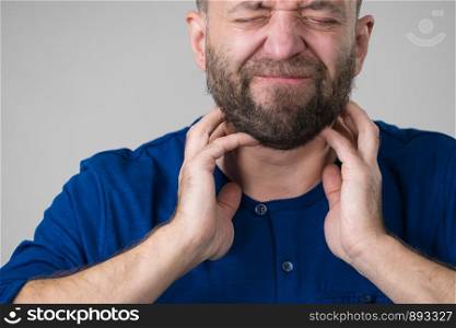 Adult man feeling hard throat, neck, lymph nodes pain. Health problems and issues concept.. Man having throat, neck pain