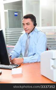 Adult man in the office talking on the phone