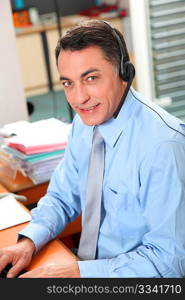 Adult man in the office talking on the phone