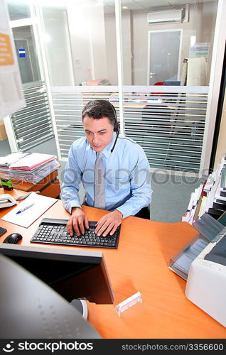 Adult man in the office talking on the phone