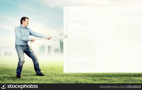 Adult man pulling blank banner