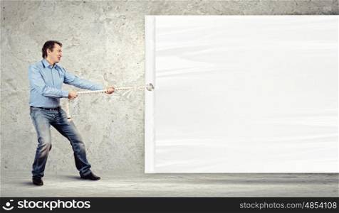 Adult man pulling blank banner. Adult man pulling blank banner. Place for text