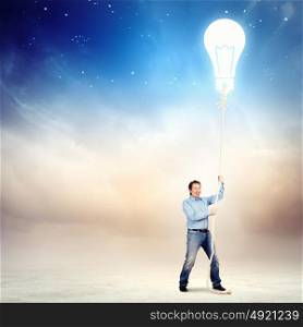 Adult man pulling rope with a bulb. Image of adult handsome man pulling rope
