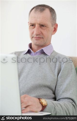 Adult man using a laptop at home