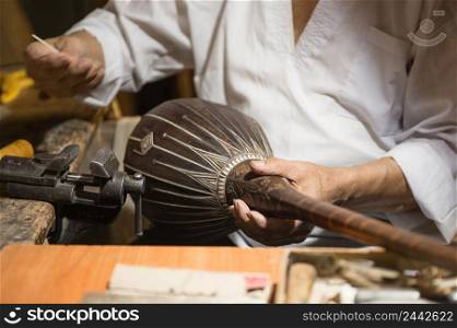 adult master restores old musical instruments. production of stringed instruments. restoration of musical instruments