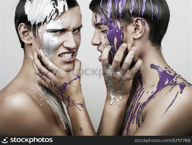 adult men in silver and violet paint