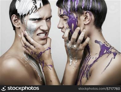 adult men in silver and violet paint