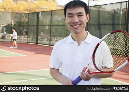 Adult men playing tennis, portrait