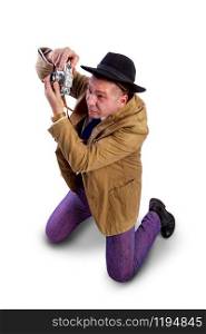 adult news photographer in a costume of the last century fashion and a wide-brimmed hat with an old camera. mature retro paparazzi