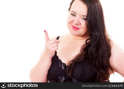 Adult plus size woman wearing lace lingerie smiling and shaking wagging her finger, rejecting gesture, disagree sign.. Big woman say no by shaking finger