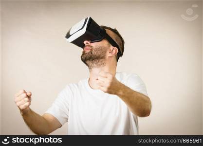 Adult short bearded guy exploring virtual reality wearing VR goggles being into technology.. Adult man wearing vr goggles