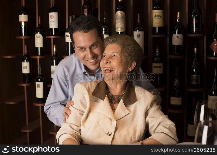 Adult son and mother dining in restaurant