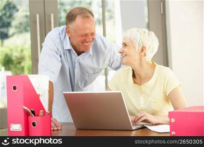 Adult Son And Senior Mother Using Laptop At Home