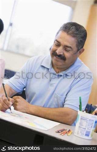 Adult student in class taking notes