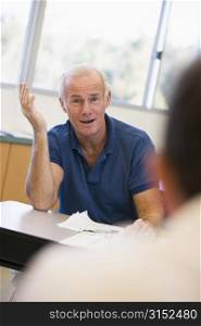 Adult student in class with teacher looking confused (selective focus)