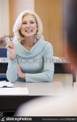Adult student in class with teacher (selective focus)
