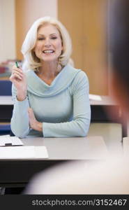 Adult student in class with teacher (selective focus)