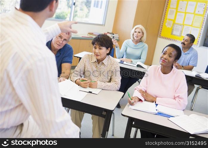 Adult students in class with teacher (selective focus)