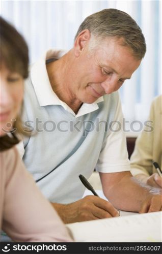 Adult students studying at table (selective focus)