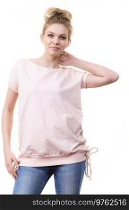 Adult woman presenting her casual beautiful outfit, short sleeved pink top and jeans.. Woman wearing casual outfit