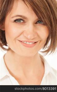 Adult woman with short brunette hair smiling at camera in close-up.. Studio shot of beautiful adult woman smiling at camera