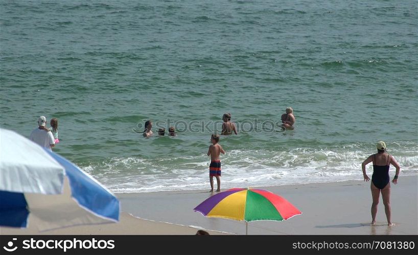 Adults and children play on Ho Hum beach on Fire Island