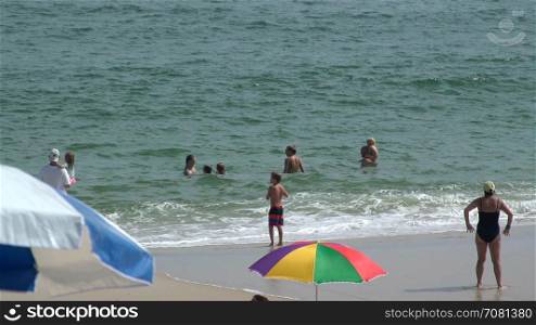 Adults and children play on Ho Hum beach on Fire Island