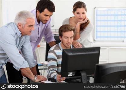 Adults around computer