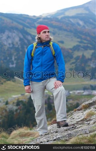 advanture man with backpack hiking on mountain forest