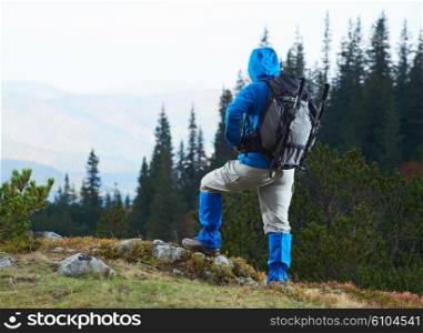 advanture man with backpack hiking on mountain forest