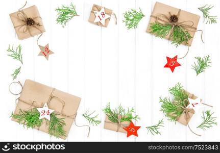 Advent calendar. Wrapped gifts with christmas decoration on bright wooden background. Flat lay
