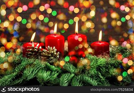 Advent decoration with four red burning candles and colorful lights. Holidays background. Selective focus, vintage style toned picture