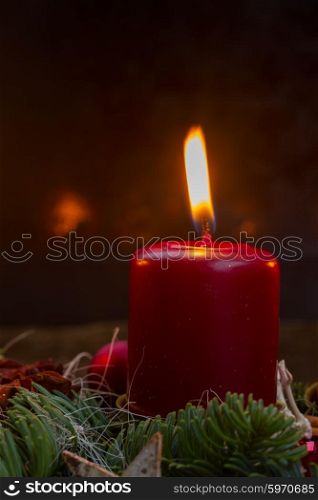 advent wreath with burning candles . Evergreen fir tree with red burning candle