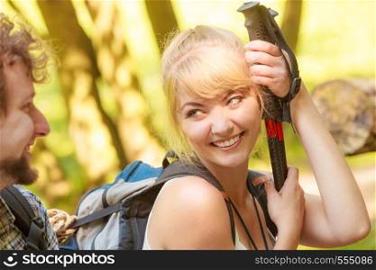 Adventure, tourism, enjoying summer time. Hiking young couple with backpacks resting on forest road