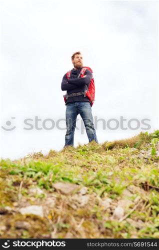 adventure, travel, tourism, hike and people concept - smiling man with backpack outdoors