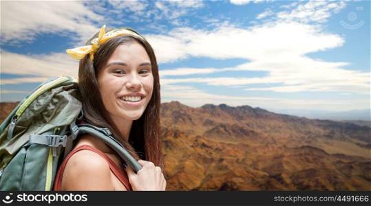 adventure, travel, tourism, hike and people concept - smiling young woman with backpack over grand canyon national park hills background. happy woman with backpack over grand canyon. happy woman with backpack over grand canyon
