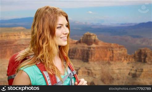 adventure, travel, tourism, hike and people concept - smiling young woman with backpack over grand canyon national park background. smiling woman with backpack over grand canyon