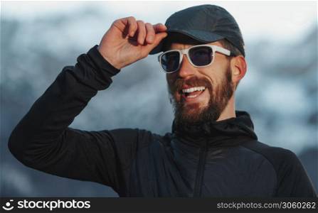 Adventurous explorer man with beard and glasses smiling