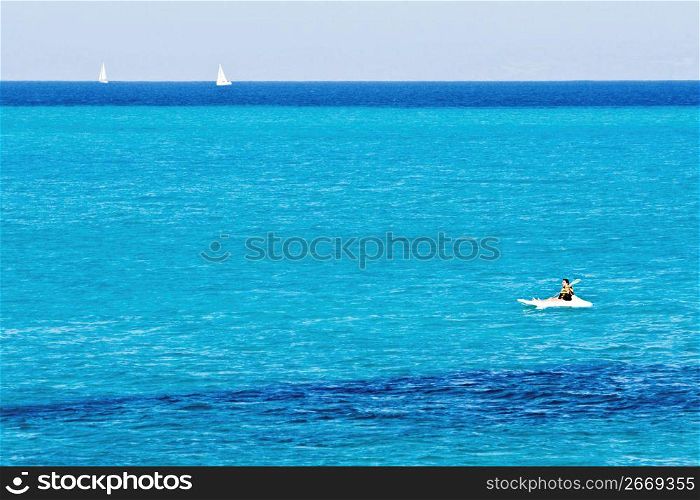 Adventurous kayaker kayaking in tropical waters while on vacation