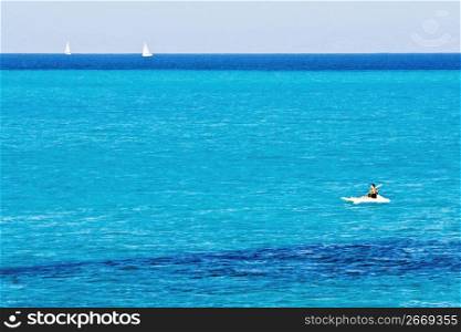 Adventurous kayaker kayaking in tropical waters while on vacation