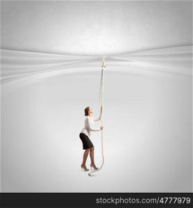 Advertise concept. Young businesswoman pulling curtain with rope. Place for text