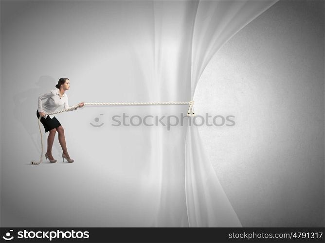 Advertise concept. Young businesswoman pulling curtain with rope. Place for text