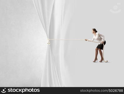 Advertise concept. Young businesswoman pulling curtain with rope. Place for text