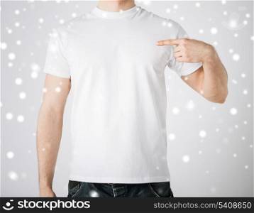 advertisement and design concept - man in blank t-shirt pointing at himself