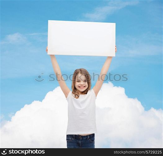 advertisement, childhood, happiness and people concept - smiling little child in white t-shirt holding blank board over blue sky with cloud background
