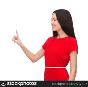 advertisement concept - attractive young woman in red dress pointing her finger